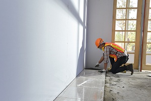 contractor installing flooring in a new home build