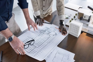 two contractors looking at a new construction blueprint